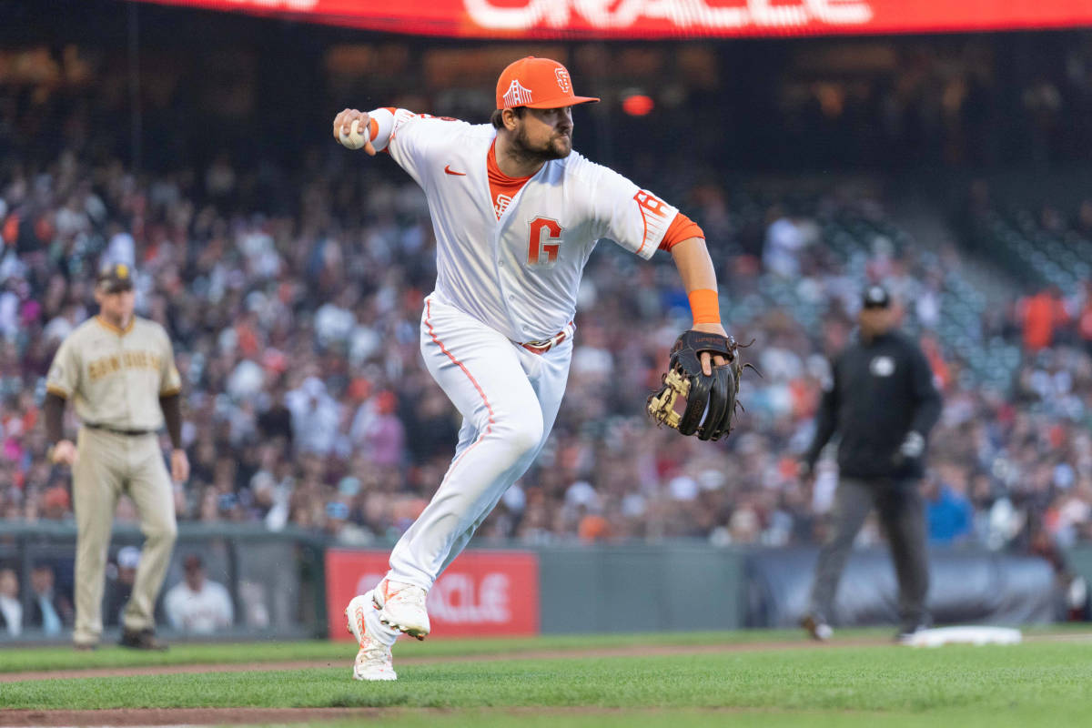SF Giants third baseman J.D. Davis throws the ball during the third inning against the San Diego Padres at Oracle Park on June 20, 2023.